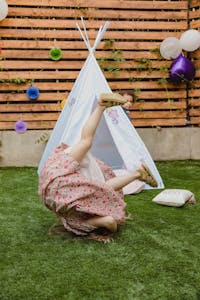 Child enjoying an outdoor summer party with playful decoration and fun activities.